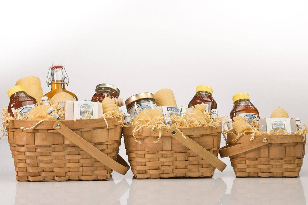 Gift box with two honey bears, a candle, lip balm, bar of soap, and a cylinder tin with a lotion bar