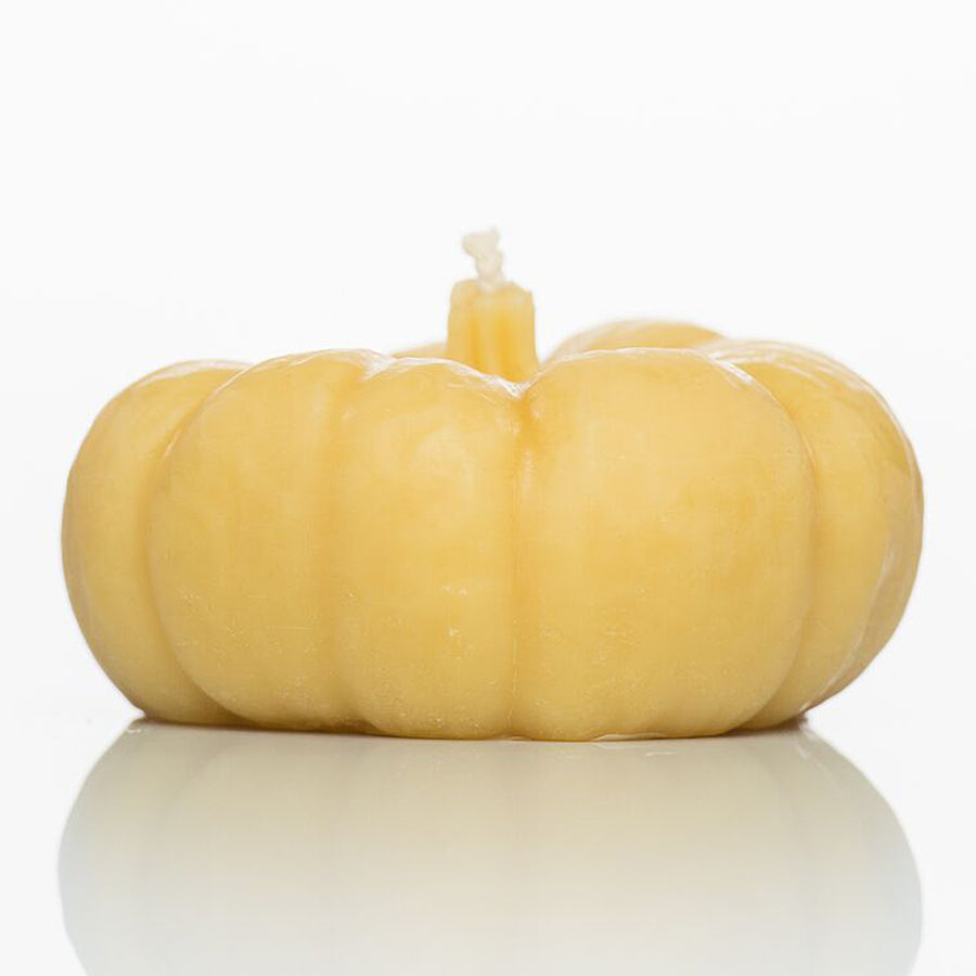 Pumpkin-shaped beeswax candle.